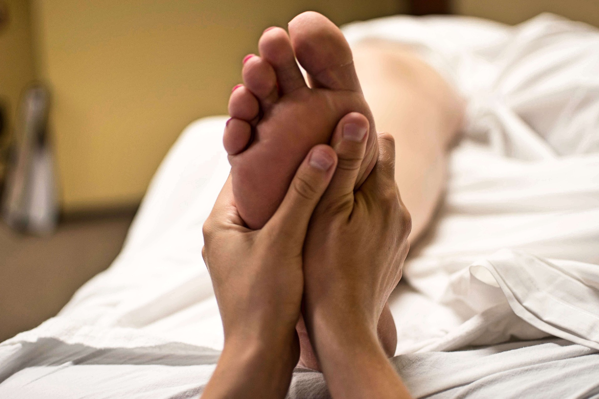 Feet being massaged by hands